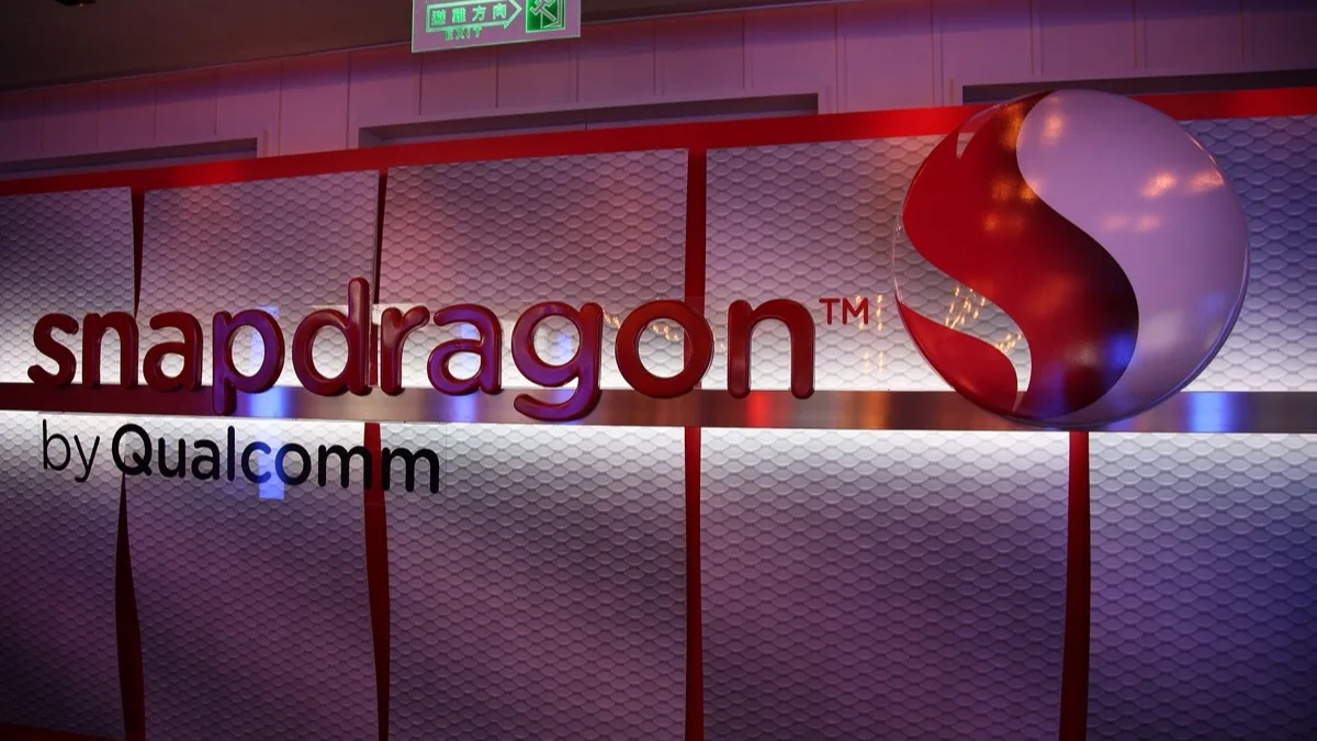 Illuminated Snapdragon by Qualcomm branding on a trade show display wall