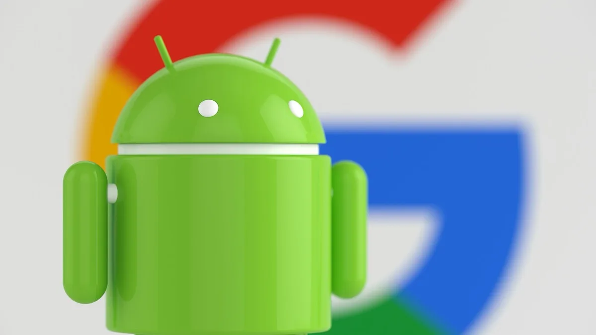 A green Android robot figure standing in front of a blurred Google logo