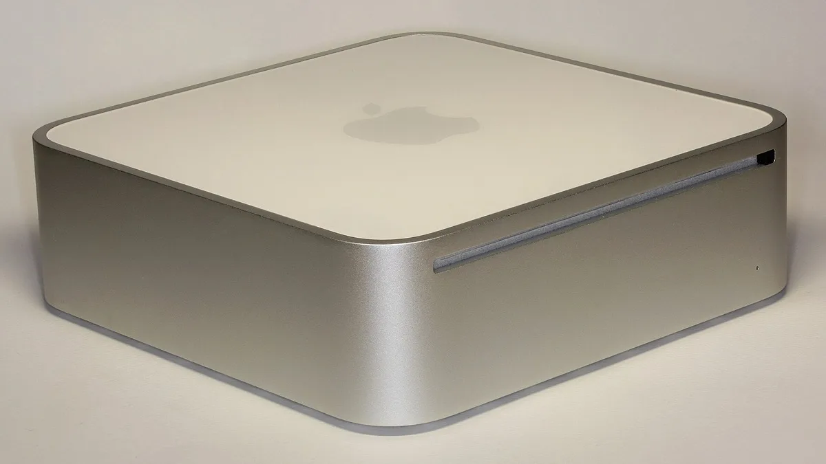 Silver aluminum Apple Mac mini desktop computer shown at an angle on a table