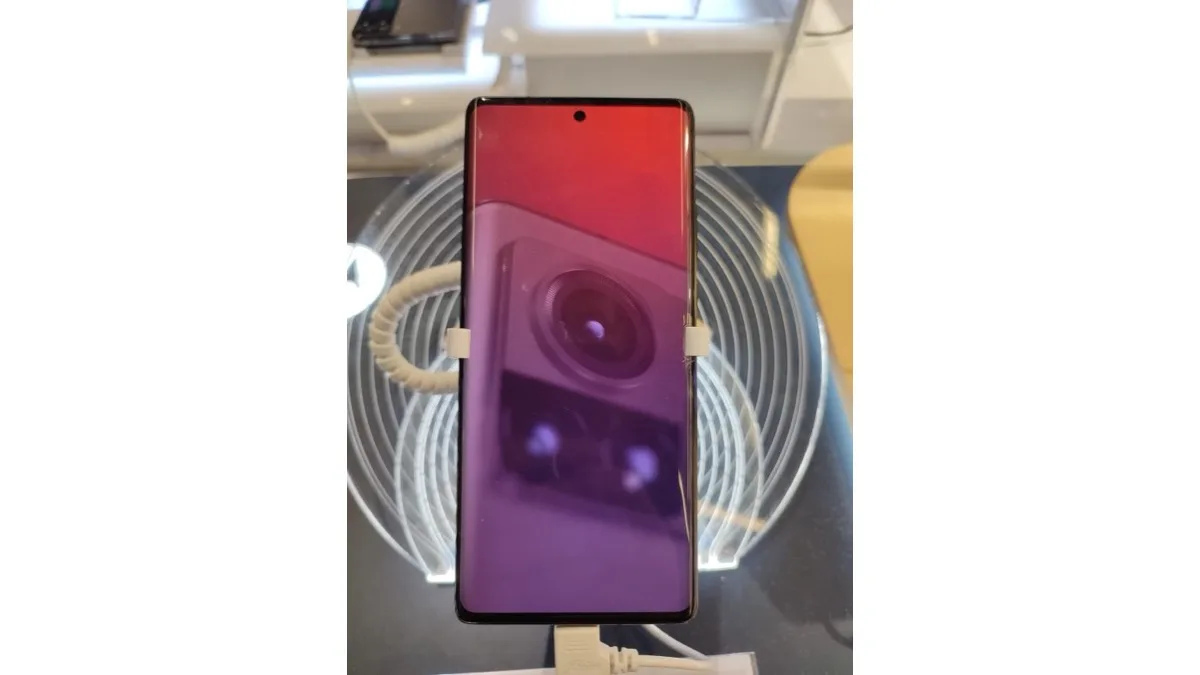 A modern Motorola Edge smartphone displaying its rear camera module on screen while resting on a stand