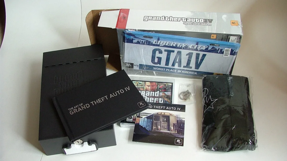 A boxed Grand Theft Auto IV Special Edition with its art book, map and metal case laid out on a table