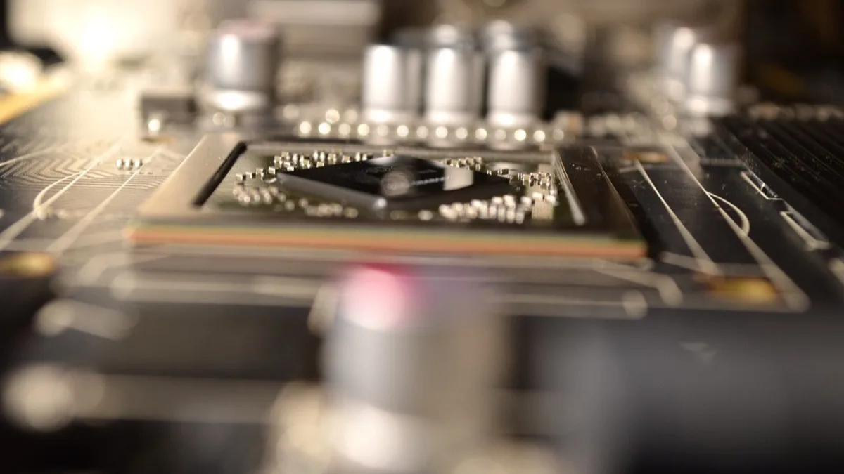 Close-up of a graphics card's GPU die and surrounding capacitors on a PCB