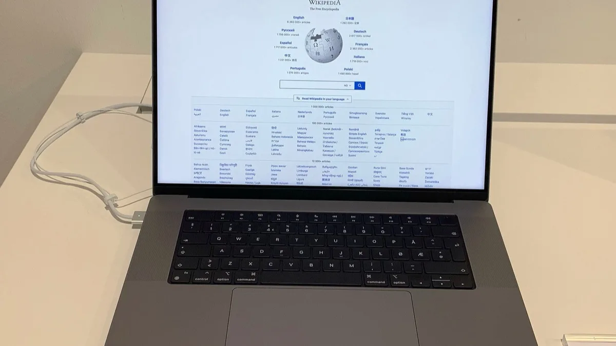 A MacBook Pro open on a desk, showing its screen and keyboard