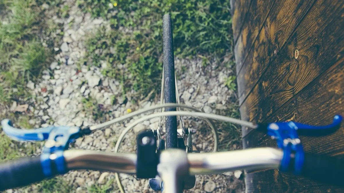 Close-up view looking down at bicycle handlebars, the kind of cylindrical shaft the LÔC8 tracker is designed to hide inside