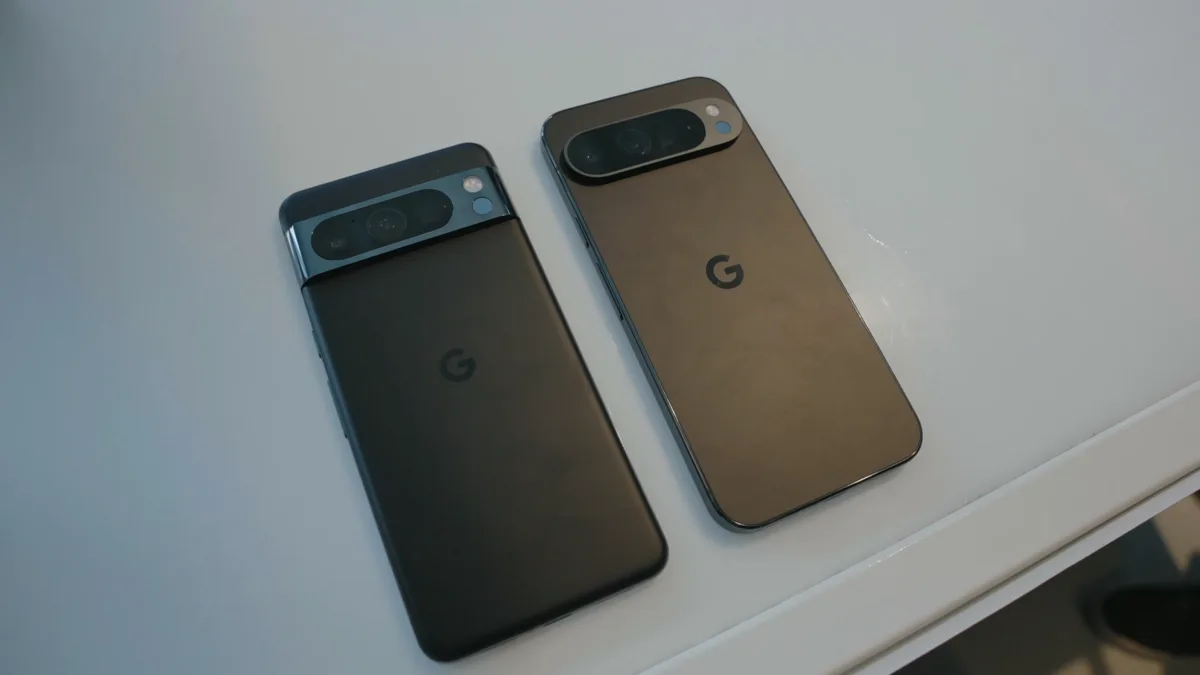 Two Google Pixel phones lying face down on a white surface, showing their rear camera bars