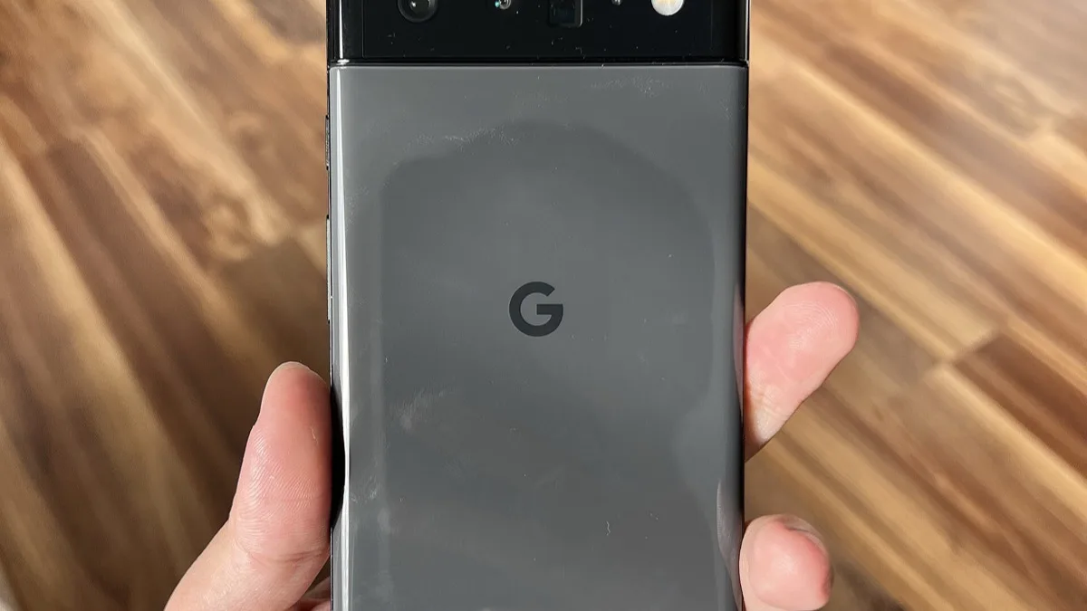 The rear of a Google Pixel phone with the Google 'G' logo, held in a hand