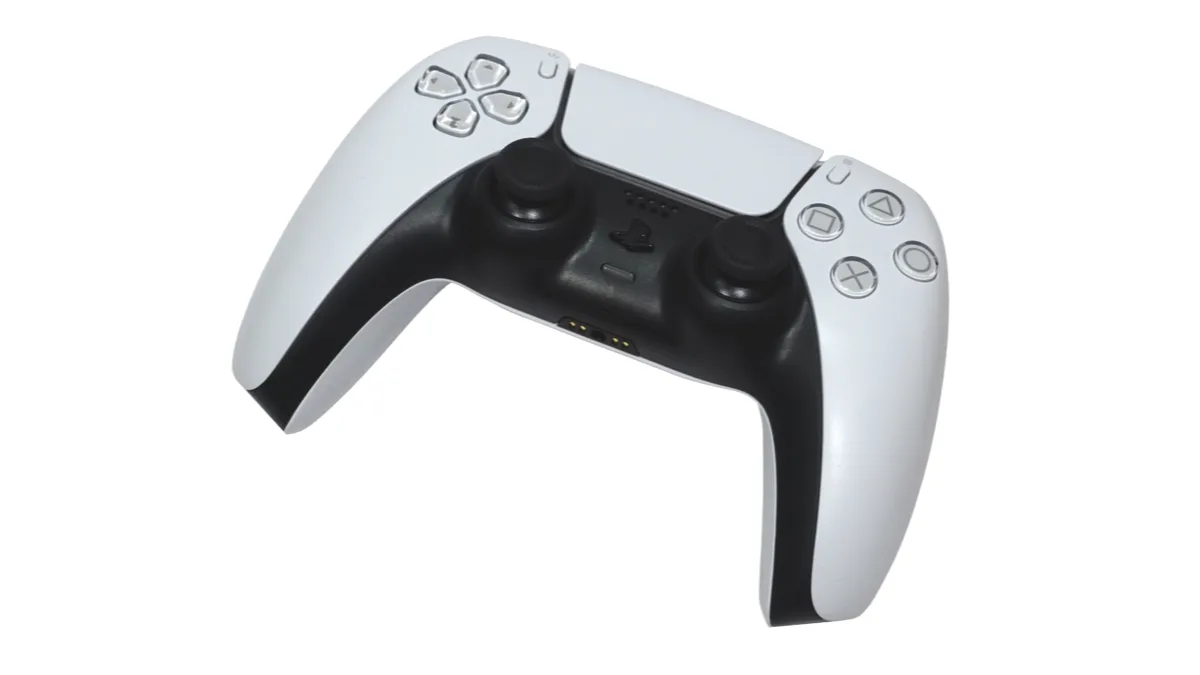A white PlayStation 5 DualSense wireless controller photographed at an angle against a plain white background
