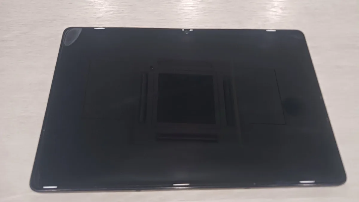 The back of a slate-style Android tablet resting on a table, representative of the budget 11-inch tablet segment TCL's new TAB A1 competes in