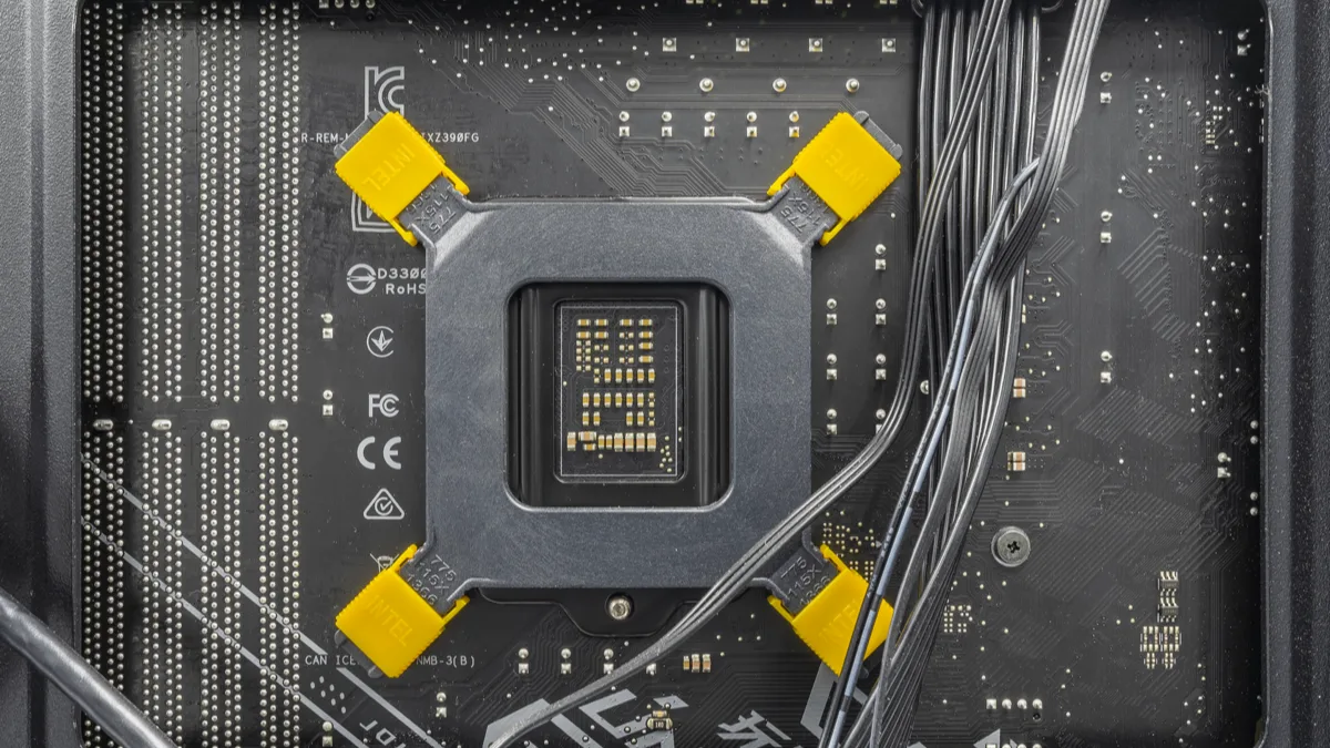 The reverse side of a gaming PC motherboard tray, showing the CPU socket backplate and routed cables