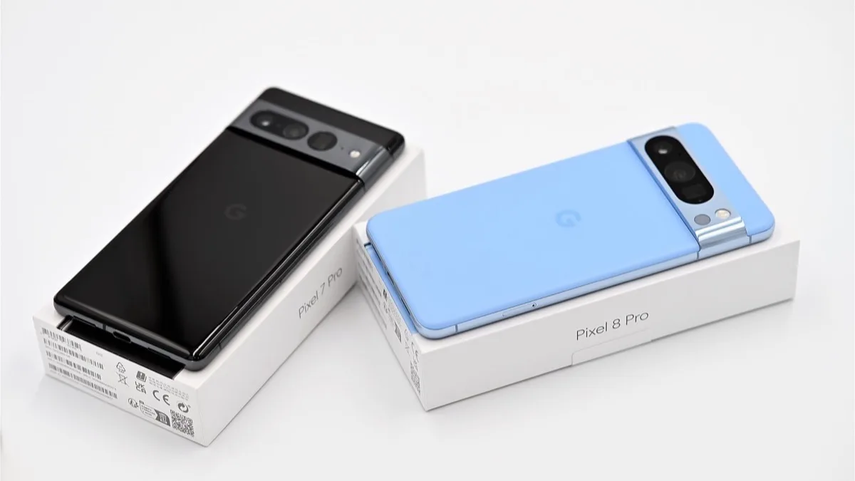 A black Google Pixel 7 Pro and a blue Pixel 8 Pro lying on their retail boxes