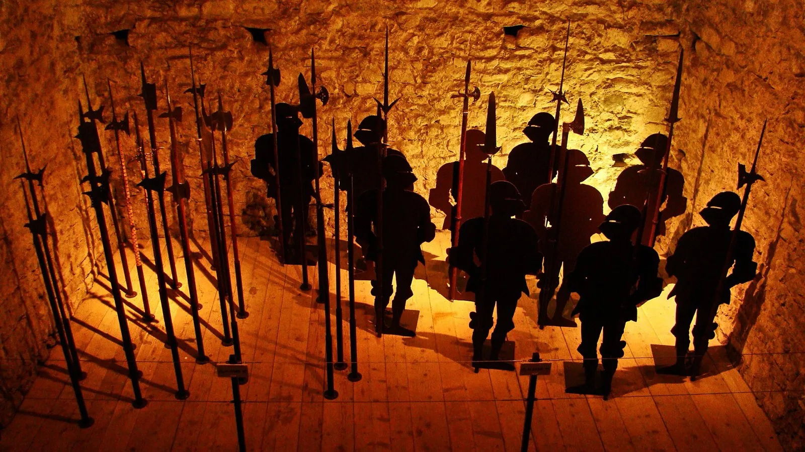 The dungeon of Chillon Castle, a stone room with pikes and soldier silhouettes