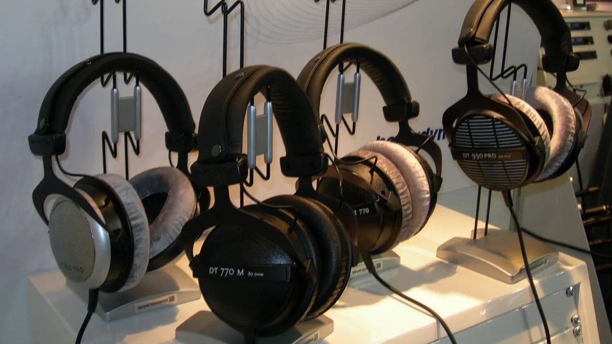 A row of beyerdynamic over-ear headphones displayed on stands at a trade show booth