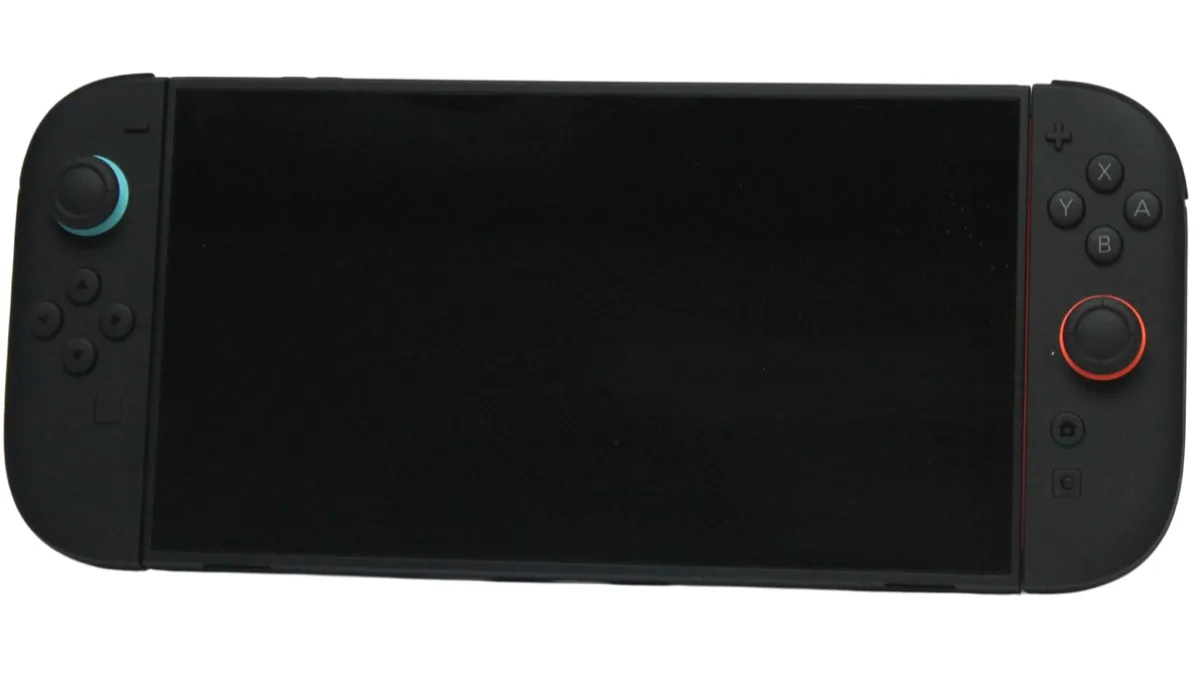 A black Nintendo Switch 2 console in handheld mode with its Joy-Con 2 controllers attached and the screen switched off