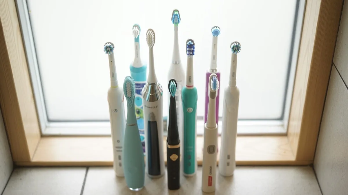 A row of electric toothbrushes with their brush heads facing up, showing the general design category Dyson's CameraJet is entering