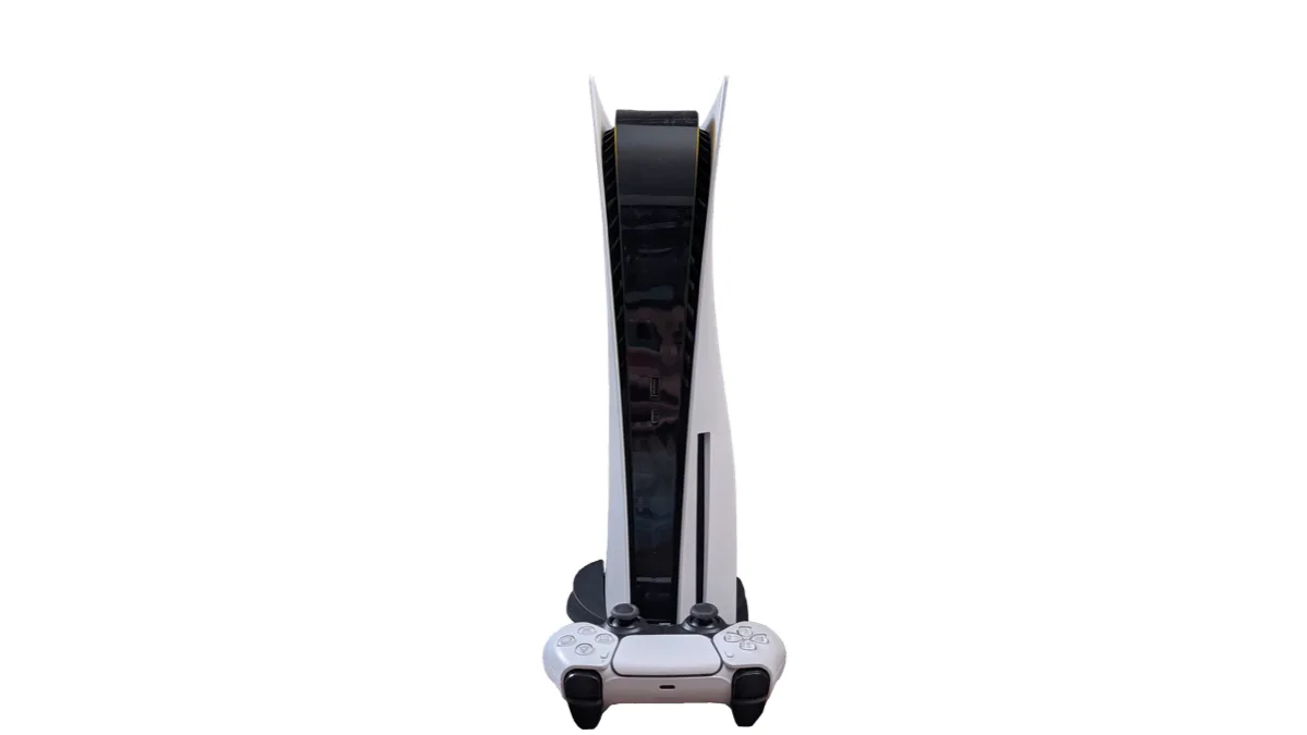A white PlayStation 5 disc console standing upright with a white DualSense controller resting in front of it against a plain background