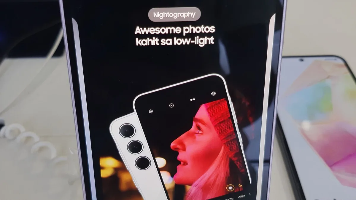 Samsung Galaxy A35 5G on a retail display stand with its screen showing the camera's Nightography promotion