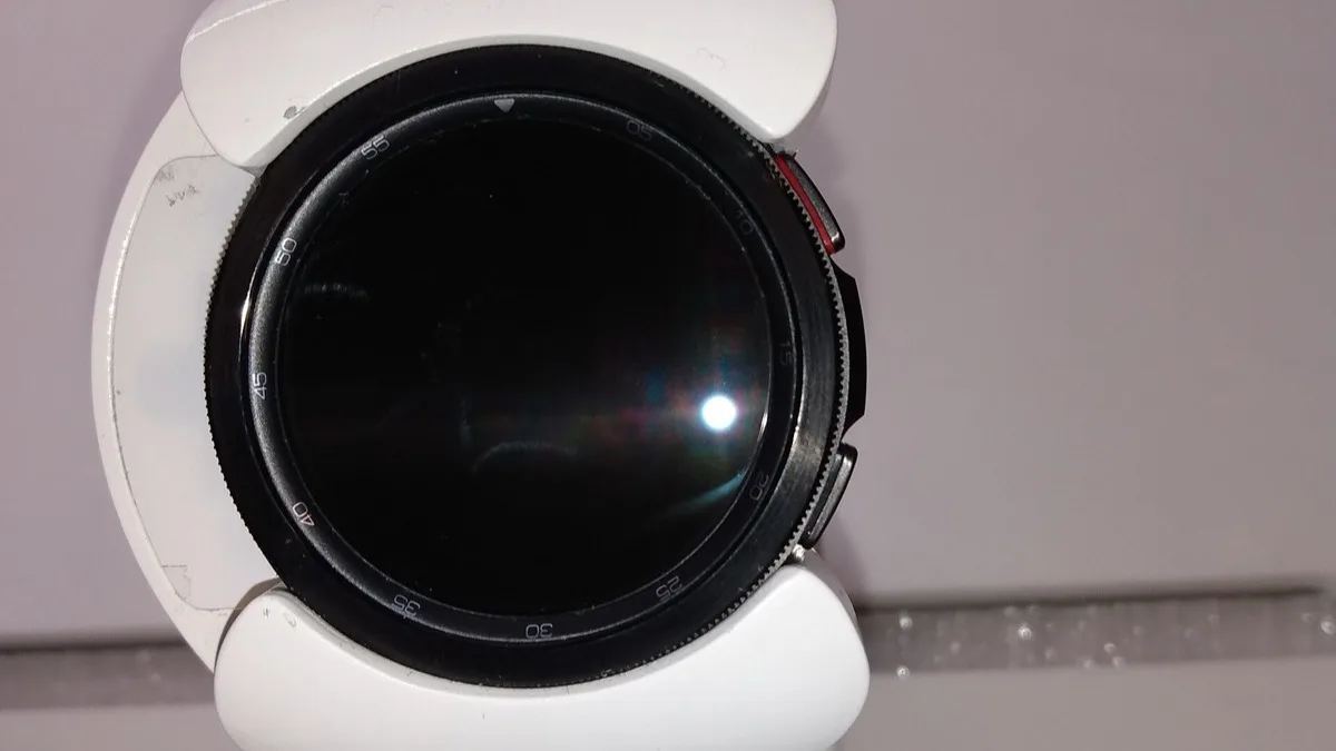 Samsung Galaxy Watch 4 Classic with its rotating bezel and white strap, screen off