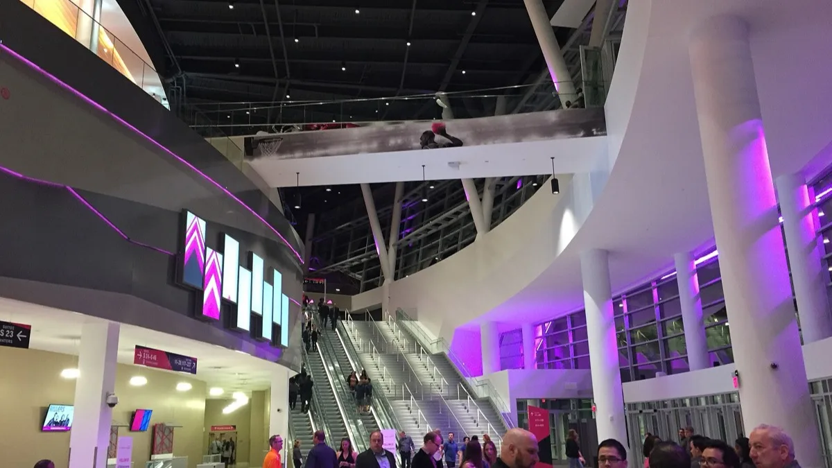 Fans walking through the lit concourse and escalators inside T-Mobile Arena in Las Vegas