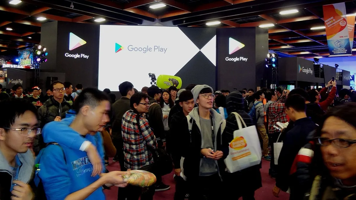 Crowds under large Google Play signs at a Google Play exhibition booth