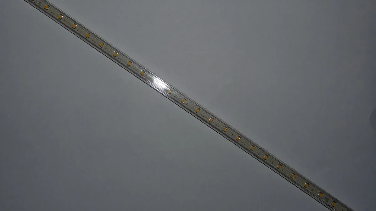 Close-up of an illuminated LED strip light with individually visible warm-white diodes