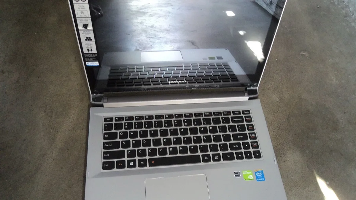 An open Lenovo IdeaPad laptop photographed from above, showing its full keyboard and trackpad