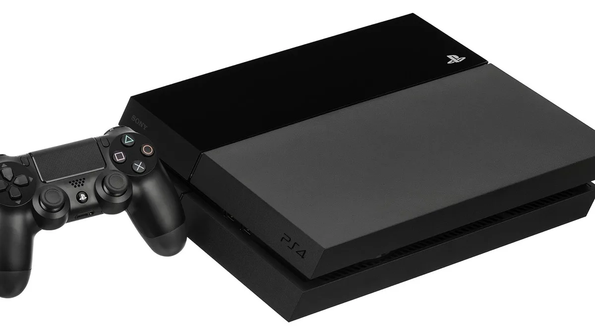 A black PlayStation 4 console lying flat beside a black DualShock 4 controller on a white background
