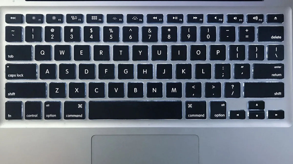 Close-up of a MacBook keyboard showing the Fn key used to trigger dictation