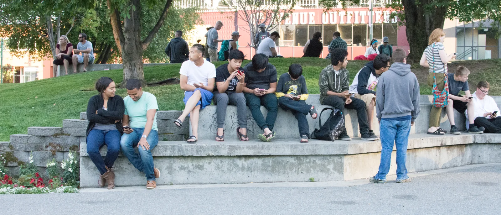 Mobile players outdoors looking at their phones, the solo-queue setting for Mobile Legends ranked in SEA