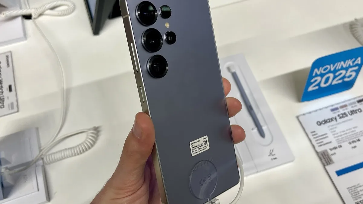 Samsung Galaxy S25 Ultra held in one hand at a retail display, showing its rear camera array