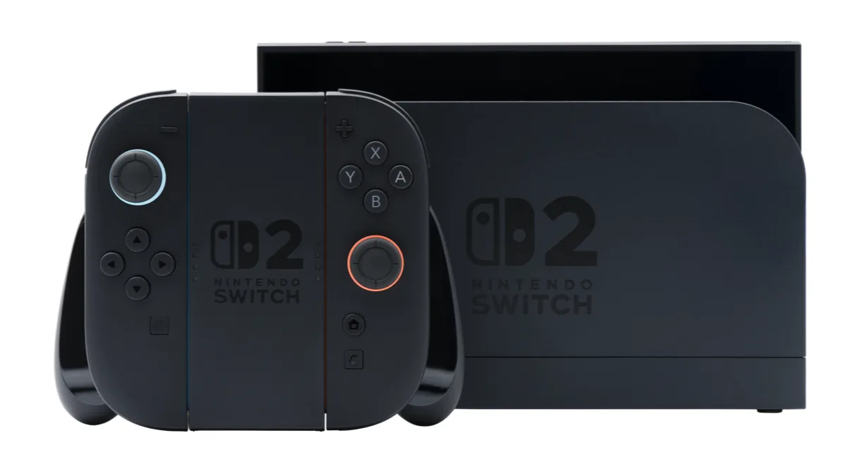 A black Nintendo Switch 2 console in its dock beside a pair of Joy-Con 2 controllers mounted in a grip
