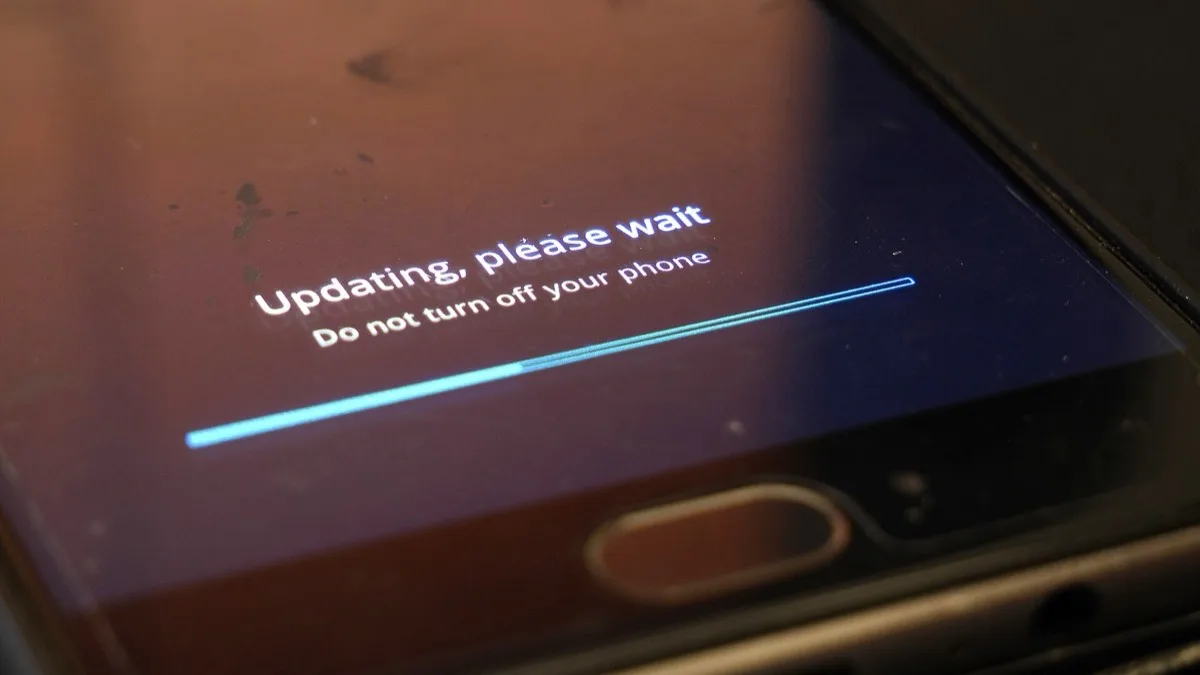 An Android phone showing an Updating, please wait progress screen during a system software update