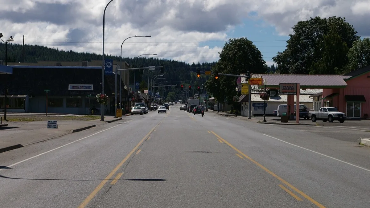 The main street of Forks, Washington, the small logging town where the Twilight novels are set, with forested hills in the distance