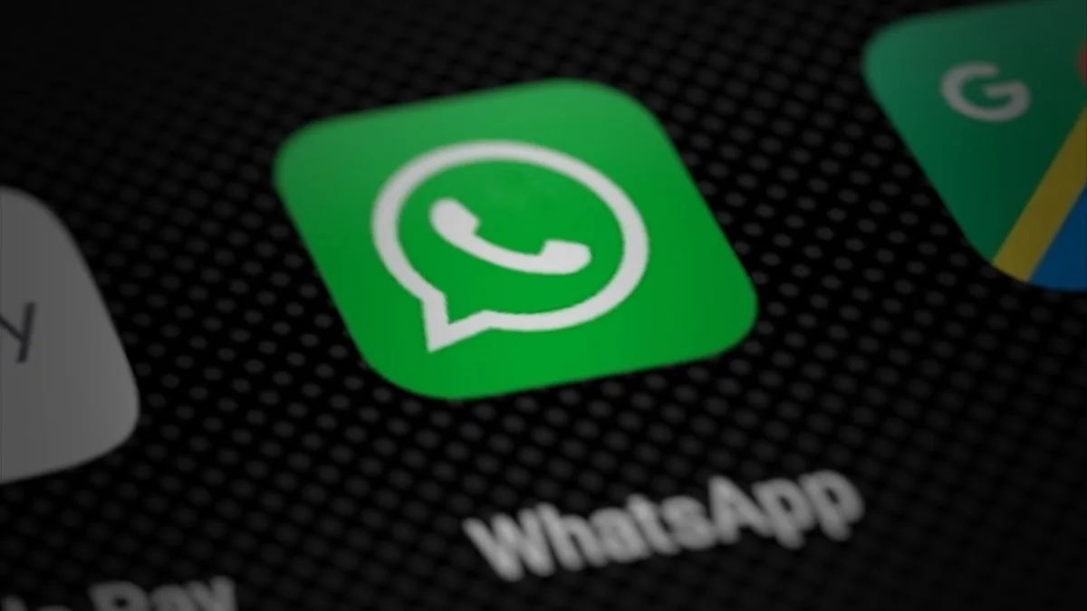 WhatsApp app icon on a smartphone home screen, shown close up