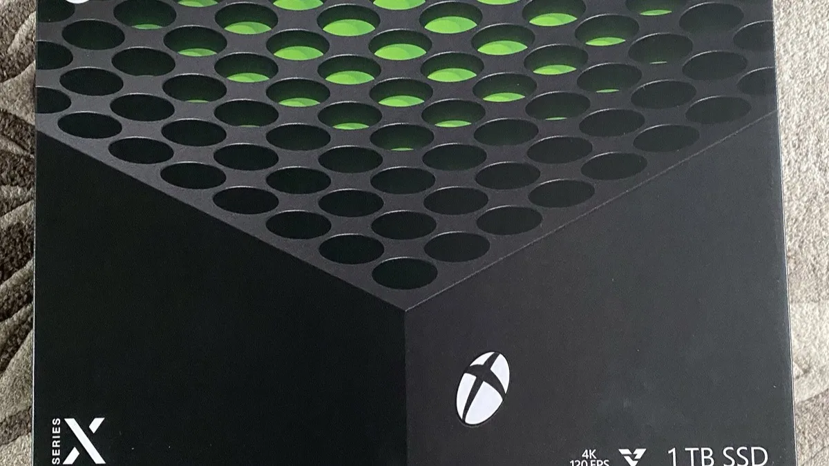 The retail box for a 1TB Xbox Series X console, showing the console's vented top surface and Xbox logo