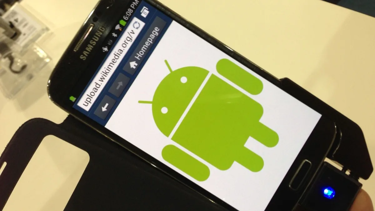 A Samsung Android phone showing the green Android robot logo on its screen
