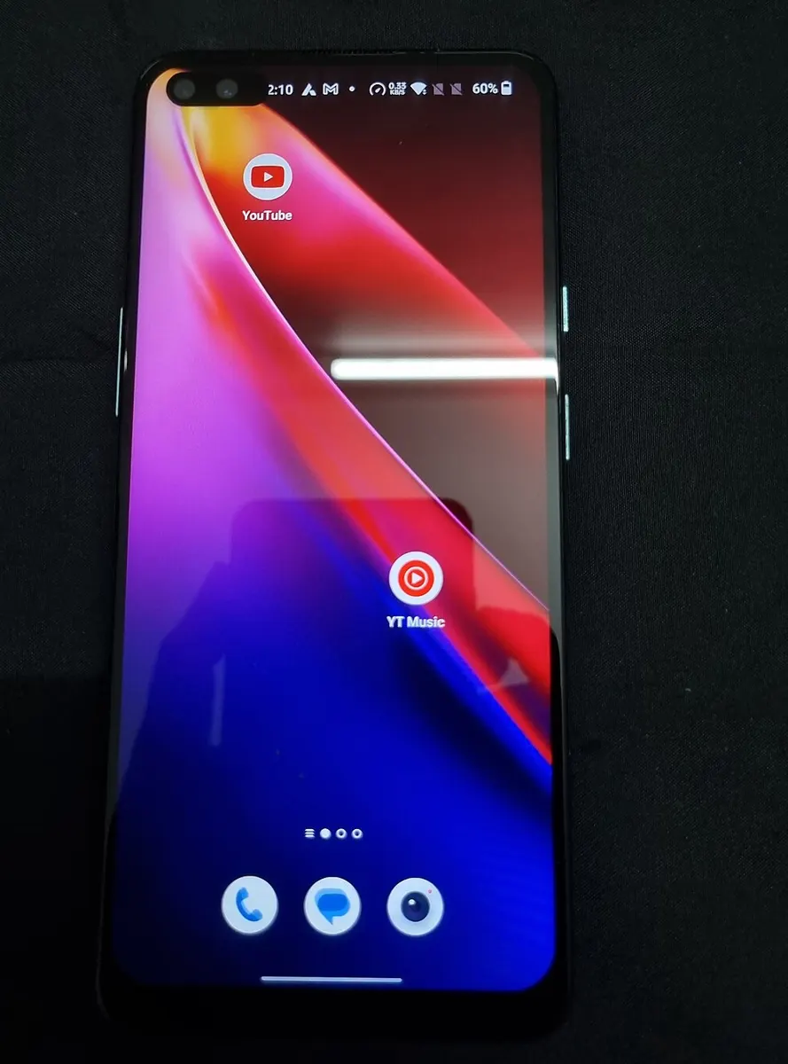 OnePlus Nord Android phone showing its home screen with YouTube and YT Music app icons