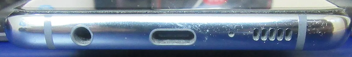 Bottom edge of a Samsung Galaxy S10+ showing the headphone jack, USB-C port, microphone pinhole, and speaker grille