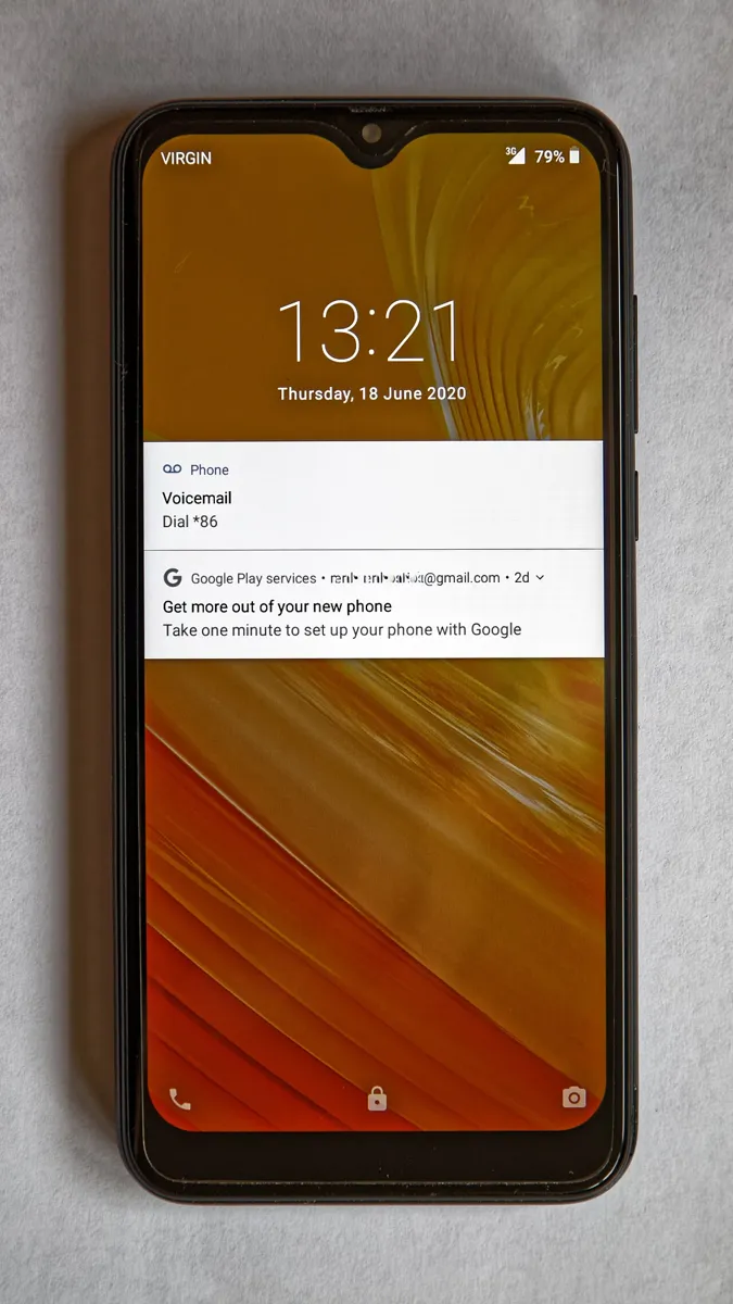 Android phone lock screen showing two notifications, each labeled with the app that sent it: Phone and Google Play services