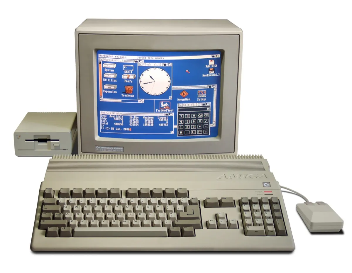 An Amiga 500 computer with a keyboard, monitor, and mouse